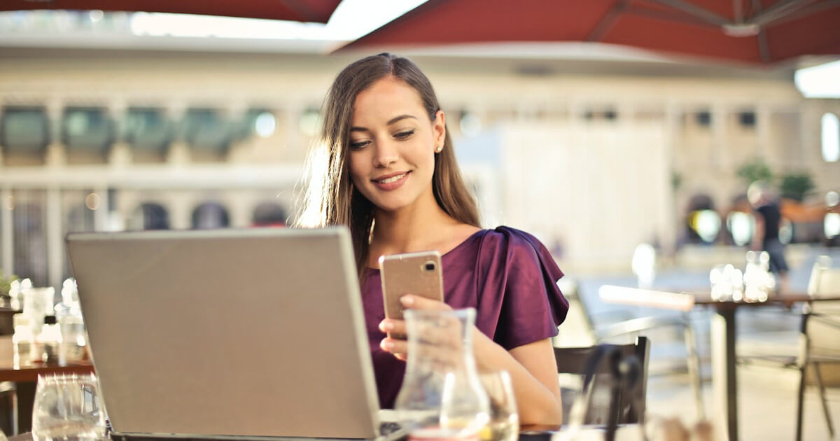 5 Ways to Keep Your Customers Engaged - woman on laptop and phone by pexels-andrea-piacquadio