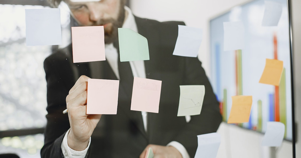 improving productivity - man writing on post it notes by pexels-gustavo-fring-6285093