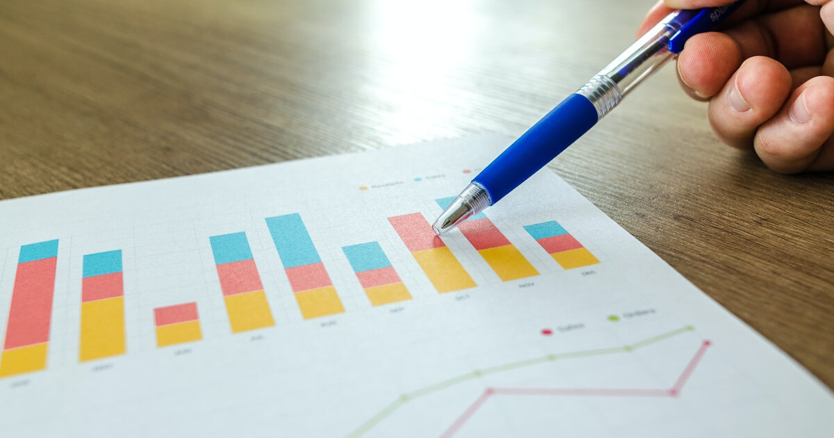 insurance agency metrics - hand with a pen pointing at graph and chart on papger by pexels-lukas