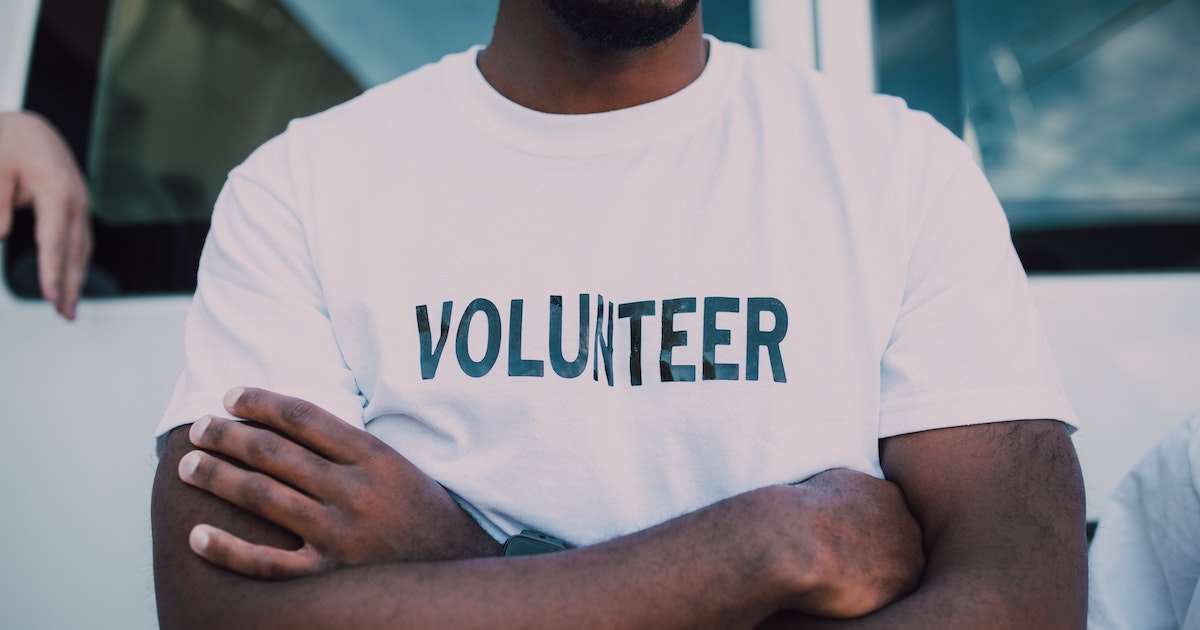 a person wearing a tshirt that says 'volunteer' on it.